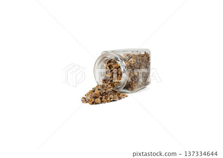Crataegus, commonly called hawthorn, quickthorn,thornapple, May-tree, whitethorn, Mayflower or hawberry falling from glass jar isolated on white background. Crataegus, commonly called hawthorn, quickthorn,thornapple, May-tree, whitethorn, Mayflower or hawberry falling from glass jar isolated on white background. 137334644
