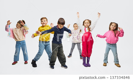 Children dancing wearing colorful mid season kids fashion outfits in studio. Children dancing wearing colorful mid season kids fashion outfits in studio. 137334846