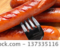 Appetizing grilled sausages on a cutting board close-up 137335116