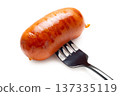 Appetizing sausage on a fork, isolated on white background 137335119