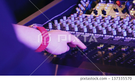 Producer Moves Fader, Hand Adjusts Mixer Controls. Sound Engineering, Studio Creativity, Modern Music Production. Producer Moves Fader, Hand Adjusts Mixer Controls. Sound Engineering, Studio Creativity, Modern Music Production. 137335570