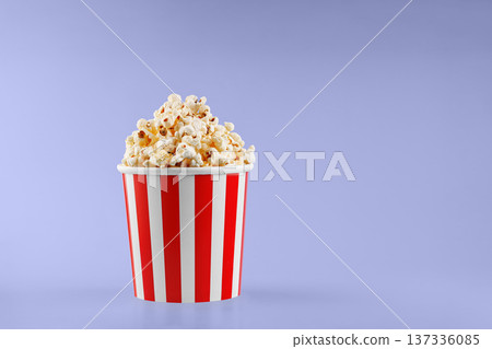 Classic red striped popcorn cardboard cup on Purple, violet background Classic red striped popcorn cardboard cup on Purple, violet background 137336085
