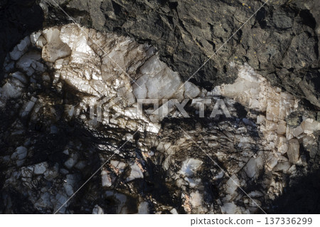 Quartz vein in volcanic rock formations under bright sunlight Quartz vein in volcanic rock formations under bright sunlight 137336299