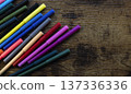 Colorful markers scattered on wooden background 137336336