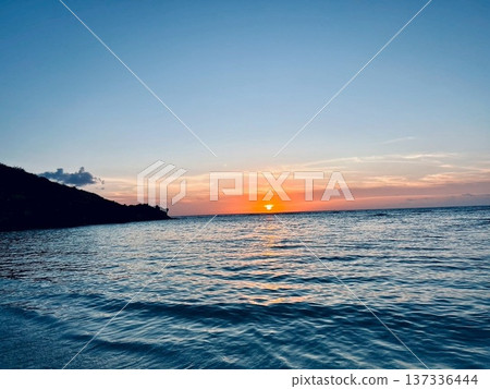 Beautiful sunset over the sea and calm ocean Beautiful sunset over the sea and calm ocean 137336444