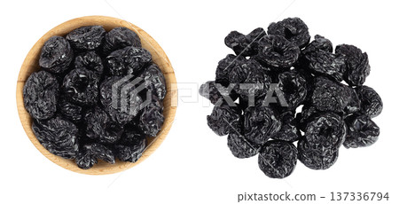 Prunes in wooden bowl isolated on white background, heap of dried plums. Top view. Flat lay Prunes in wooden bowl isolated on white background, heap of dried plums. Top view. Flat lay 137336794