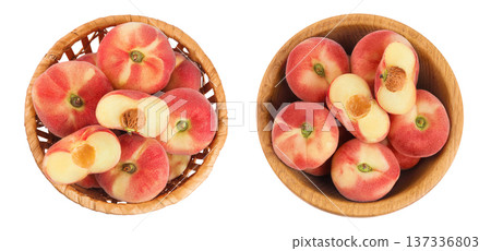 chinese flat donut peaches in a wicker basket and wooden bowl isolated on white background. Top view. Flat lay 137336803