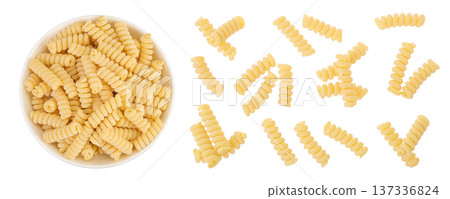Italian spiral shaped pasta, Fusilli bucati macaroni in ceramic bowl, isolated on white background. Top view. Flat lay. Italian spiral shaped pasta, Fusilli bucati macaroni in ceramic bowl, isolated on white background. Top view. Flat lay. 137336824
