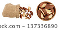 Brasil nuts in sackcloth bag and wooden bowl isolated on white background with full depth of field. Top view. Flat lay 137336890