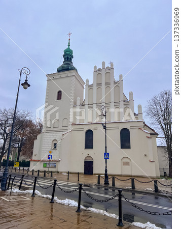 Historic church building with unique design in a city square on a cloudy day 137336969