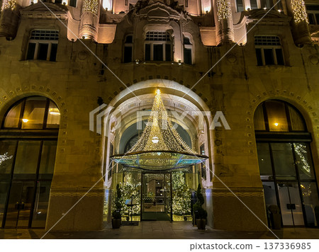 building in Budapest with large windows and chandeliers with ornate architecture building in Budapest with large windows and chandeliers with ornate architecture 137336985