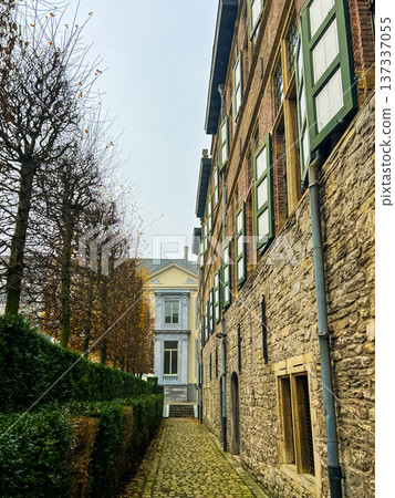 Charming winter alleyway with brick houses and green hedges in Ghent, Belgium Charming winter alleyway with brick houses and green hedges in Ghent, Belgium 137337055