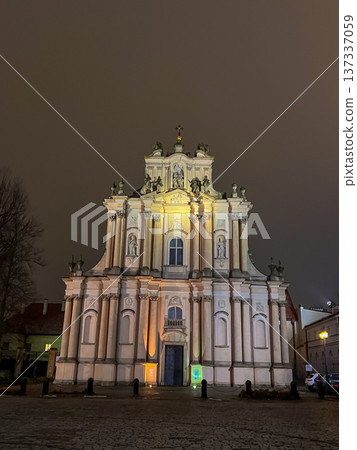 Visitationist Church exterior lit at night in empty square with dark sky, Warsaw 137337059