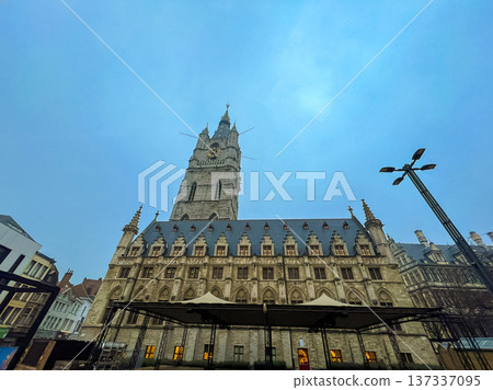 Stunning view of belfry tower and cathedral in historic Ghent under blue skies Stunning view of belfry tower and cathedral in historic Ghent under blue skies 137337095