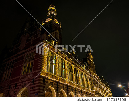 Nighttime photograph of Leuven universitys grandiose hall illuminated by lights 137337106