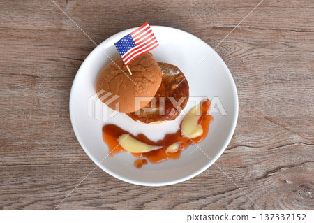 fried mashed pork hamburger with Italian tomato sauce stick USA flag dressing mayonnaise on plate 137337152