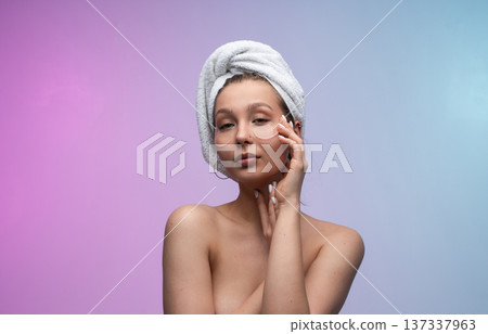 Young woman enjoying self-care routine with under eye patches and hair wrapped in a white towel, radiating natural beauty, wellness, and a relaxing spa experience Young woman enjoying self-care routine with under eye patches and hair wrapped in a white towel, radiating natural beauty, wellness, and a relaxing spa experience 137337963