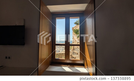Aegean Sea and white townscape under the blue sky seen through wooden window Aegean Sea and white townscape under the blue sky seen through wooden window 137338895