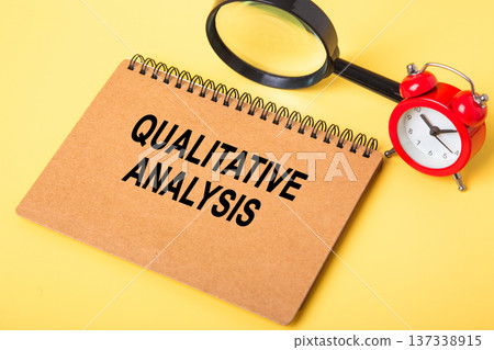 Qualitative analysis concept on notebook with magnifying glass Qualitative analysis concept on notebook with magnifying glass 137338915