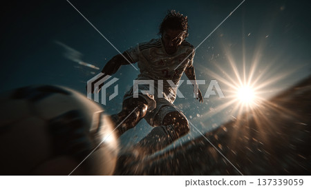 A player kicking a soccer ball dynamically in backlight A player kicking a soccer ball dynamically in backlight 137339059