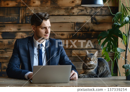 A person in a business suit sitting at a desk with a laptop, accompanied by a cat on the wooden desk. The background features a wooden wall with a green plant. Generative Ai 137339254
