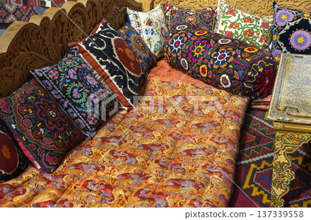 Vibrant embroidered cushions and richly patterned textiles 137339558