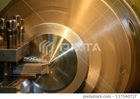 Close-up of a precision finish cutting operation on a brass component using a metal lathe machine to achieve high surface integrity. 137340717