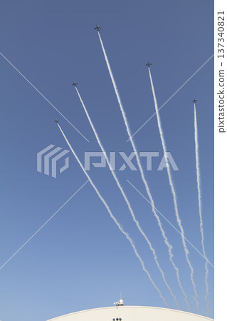 An airplane cloud extending into the blue sky 137340821
