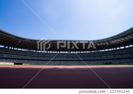 A huge stadium, an indoor athletics stadium with spectator seats A huge stadium, an indoor athletics stadium with spectator seats 137341241