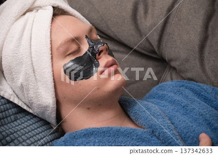 Man resting with black face mask. Mens Home Self-Care Routine 137342633