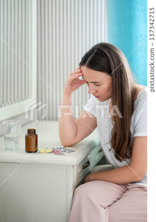 A young woman eats strawberries in the kitchen A young woman eats strawberries in the kitchen 137342715