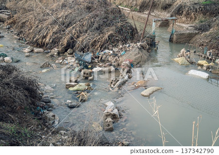Polluted River with Debris and Waste Polluted River with Debris and Waste 137342790