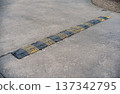 Rubber Speed Bump on Concrete Surface 137342795