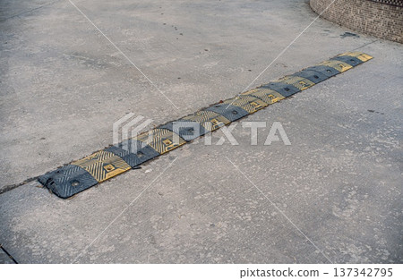 Rubber Speed Bump on Concrete Surface 137342795