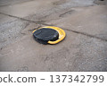 Parking Disk on Cracked Concrete Surface 137342799