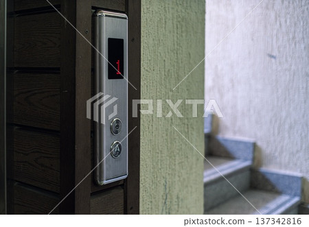 Elevator Control Panel with Stairs in the Background Elevator Control Panel with Stairs in the Background 137342816