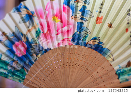 Colorful floral folding hand fan close-up Colorful floral folding hand fan close-up 137343215