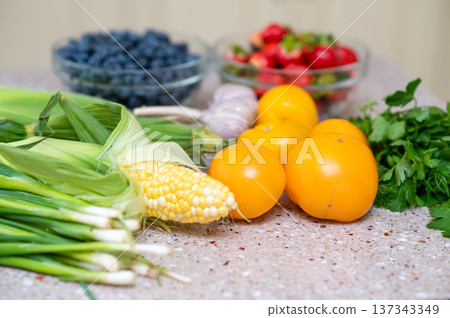 Fresh vegetables and berries on kitchen counter in natural light Fresh vegetables and berries on kitchen counter in natural light 137343349