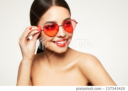Young model woman in sunglasses in the shape of hearts 137343420