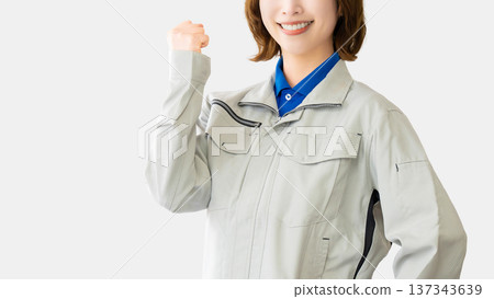 A woman in work clothes doing a guts pose 137343639