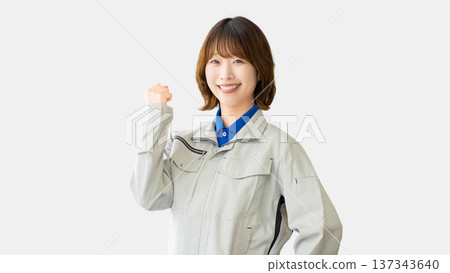 A woman in work clothes doing a guts pose A woman in work clothes doing a guts pose 137343640