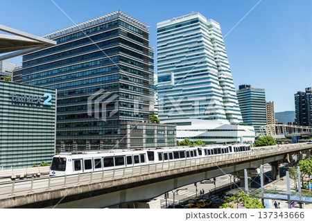 A train on the Wenhu or Brown Line of the Taipei MRT passes by the modern metropolis building in Nangang Software Park Area. A train on the Wenhu or Brown Line of the Taipei MRT passes by the modern metropolis building in Nangang Software Park Area. 137343666
