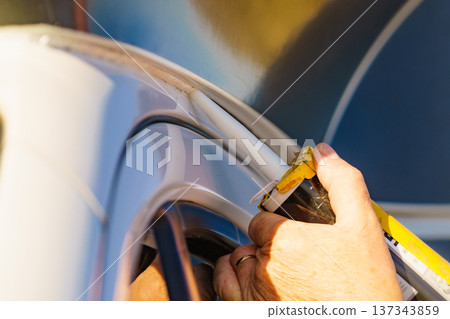 Applying silicon on caravan body 137343859