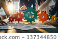 Close up of colorful gears as team collaborates on project with charts and data in bright office setting during afternoon 137344850