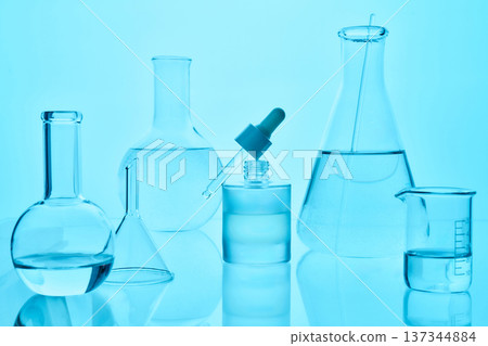Scientific laboratory glassware with liquid for research experiment 137344884