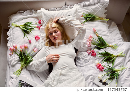 Serene flower resting, Soft light highlights tranquil woman surrounded by scattered petals and tulips Serene flower resting, Soft light highlights tranquil woman surrounded by scattered petals and tulips 137345767