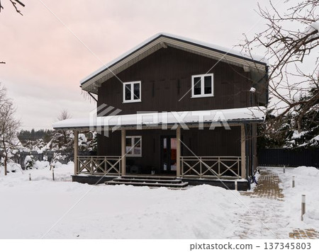 Warm reception at snowcovered cabin with inviting ambiance 137345803