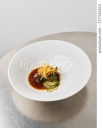Slowcooked beef served alongside fresh vegetables and savory sauce Slowcooked beef served alongside fresh vegetables and savory sauce 137345823