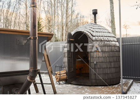 Cozy winter sauna arrangement with surrounding natural elements 137345827