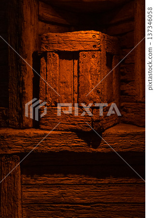 Rough wooden crate on shelf in warm dim light 137346058